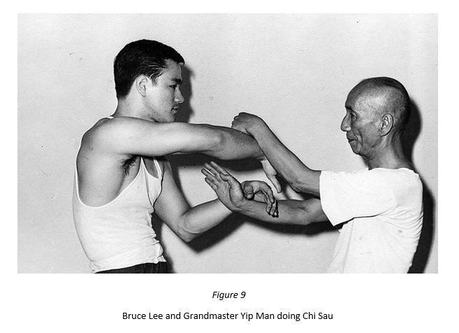 Grandmaster Yip Man and Bruce Lee engaged in Chi Sau.
